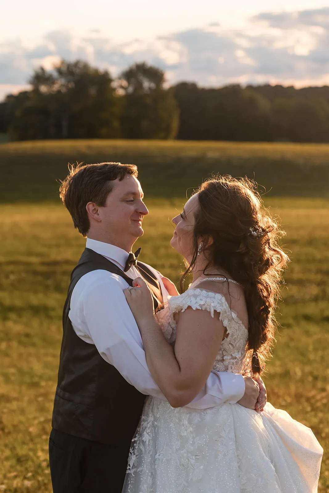 Couple dancing in a golden field at sunset