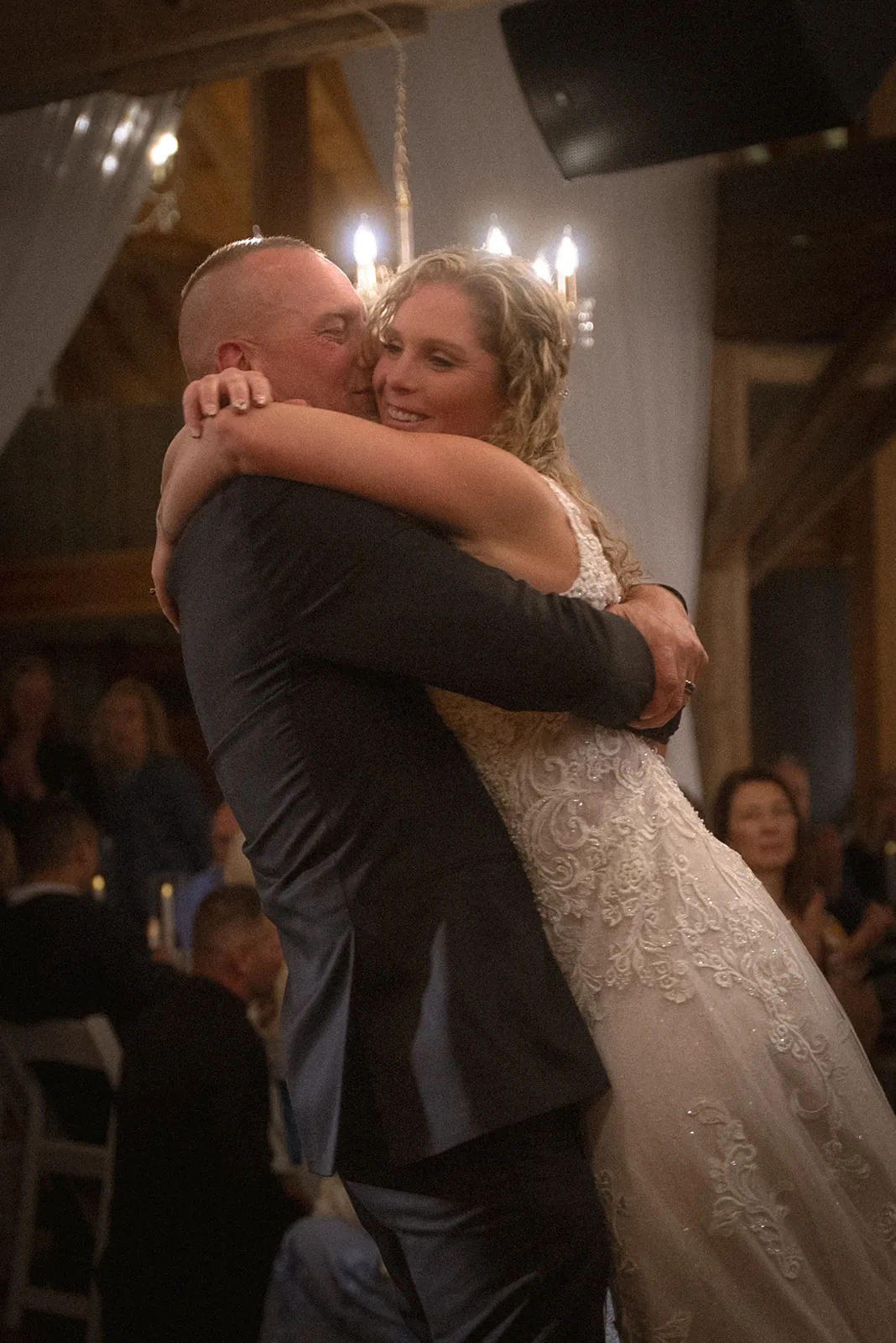 First dance embrace under string lights