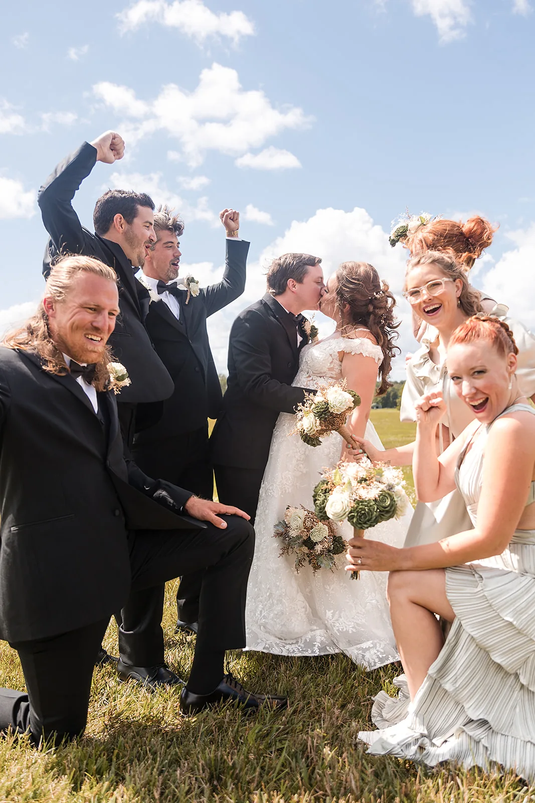 Full wedding party group celebrating