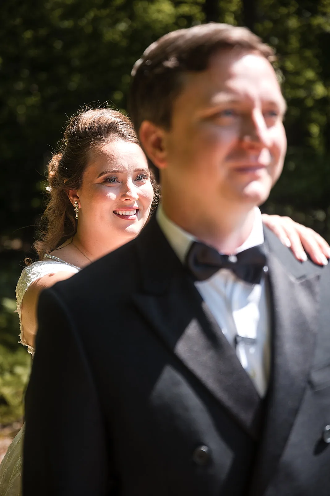 bride and groom recessional kiss, wide shot with guests standing