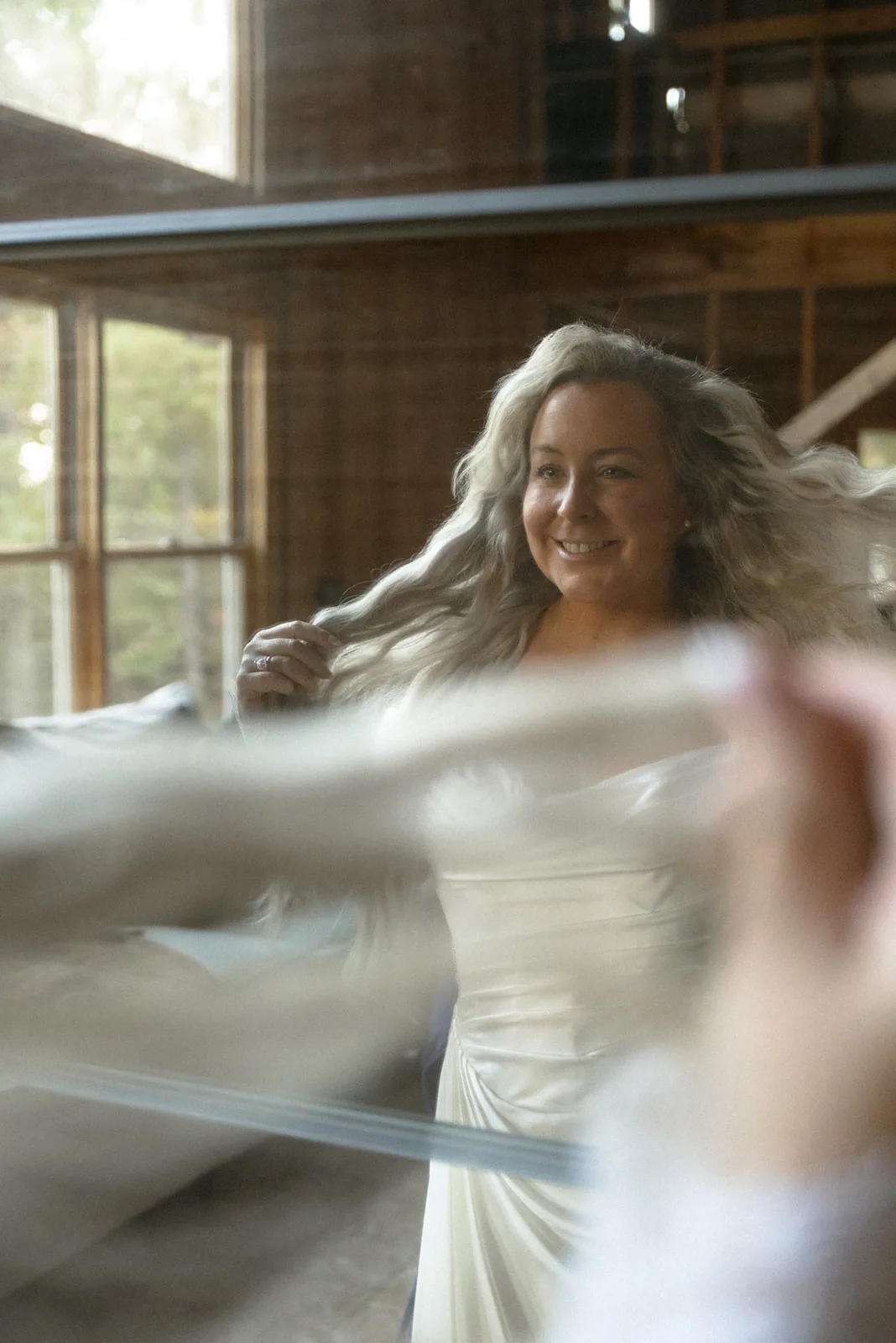 bride with hair blowing, candid motion portrait indoors