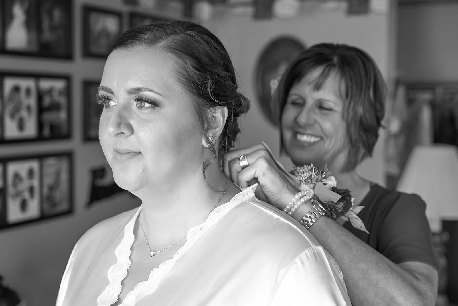 Black white bride being helped corsage — Chelsea & Jake's wedding at Ogemaw County Fairgrounds, West Branch, MI