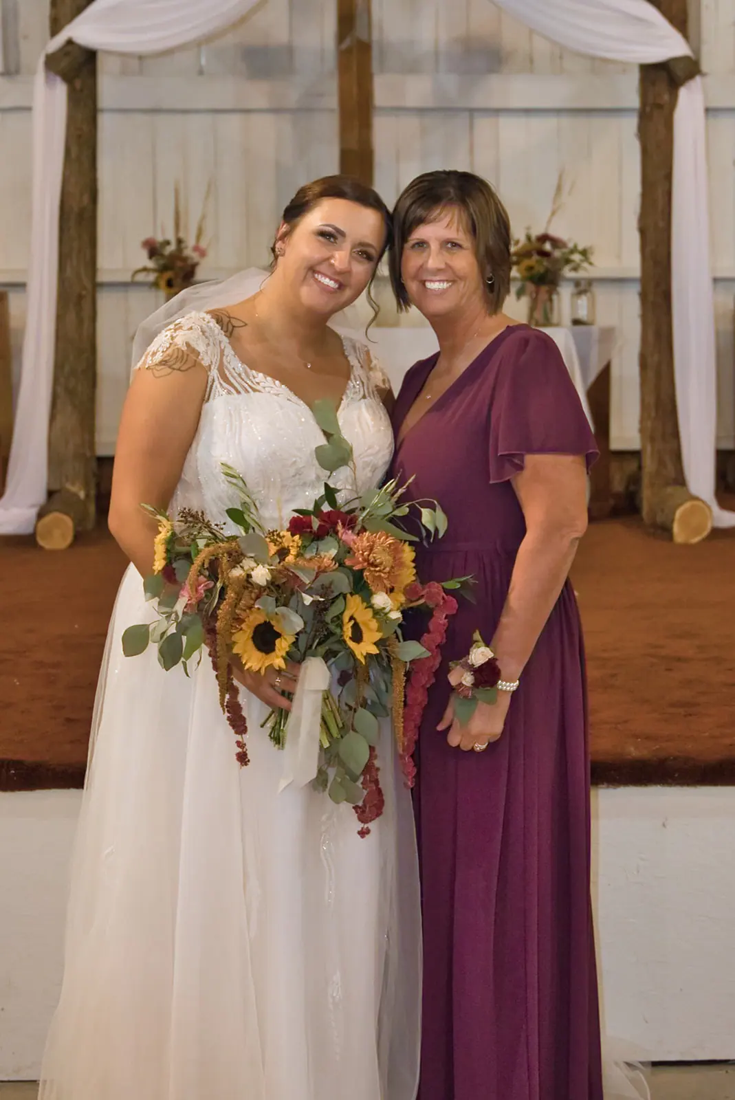 Bride mother both barn bouquet hand — Chelsea & Jake's wedding at Ogemaw County Fairgrounds, West Branch, MI