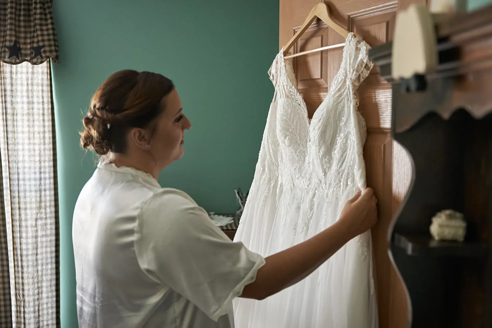 Bride white robe hanging wedding gown — Chelsea & Jake's wedding at Ogemaw County Fairgrounds, West Branch, MI