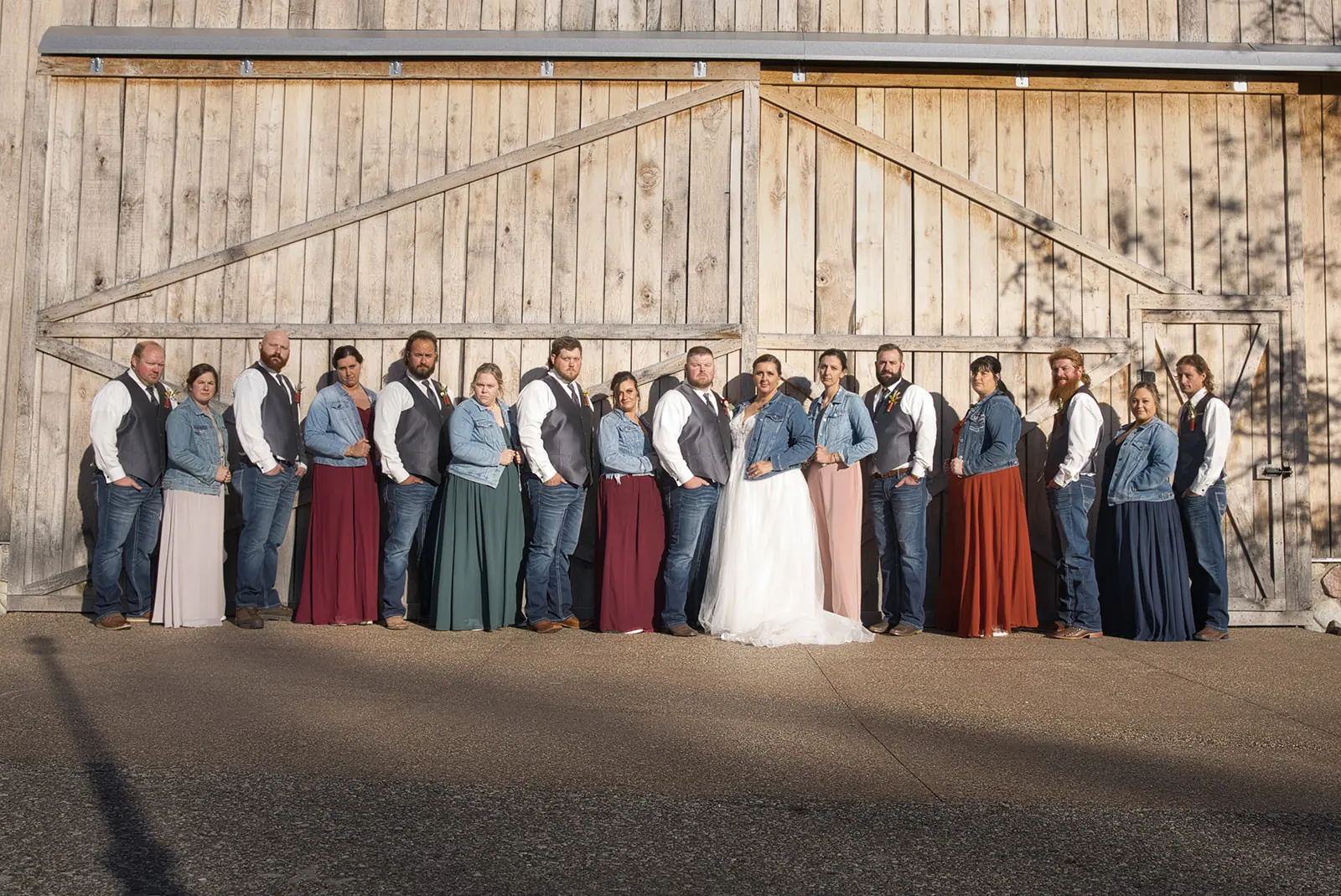 Wedding party lined front wooden barn — Chelsea & Jake's wedding at Ogemaw County Fairgrounds, West Branch, MI