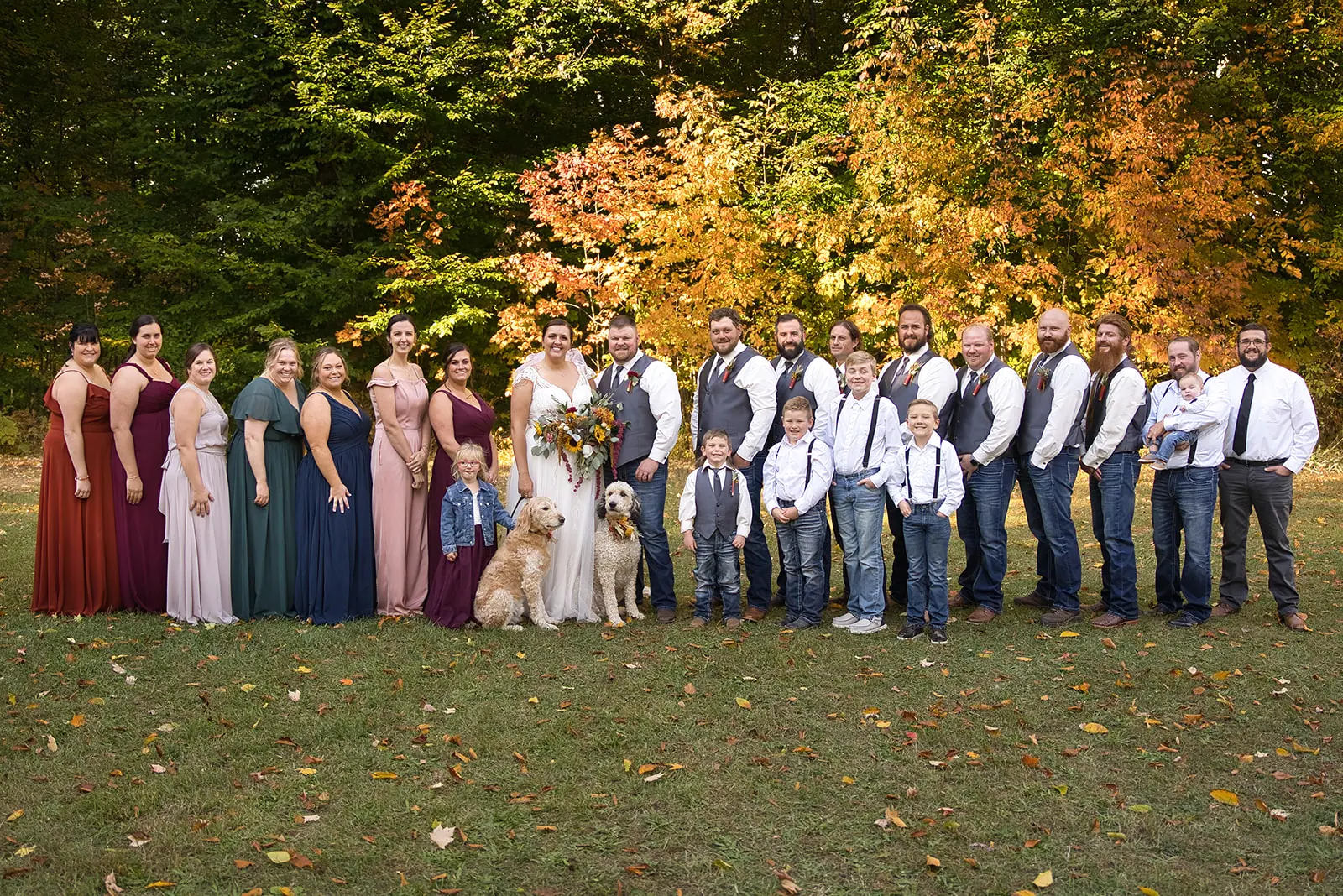 Wide group photo full wedding party — Chelsea & Jake's wedding at Ogemaw County Fairgrounds, West Branch, MI