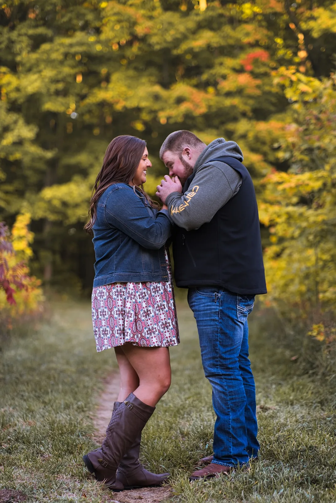 couple nose-to-nose portrait in forest, fall colors
