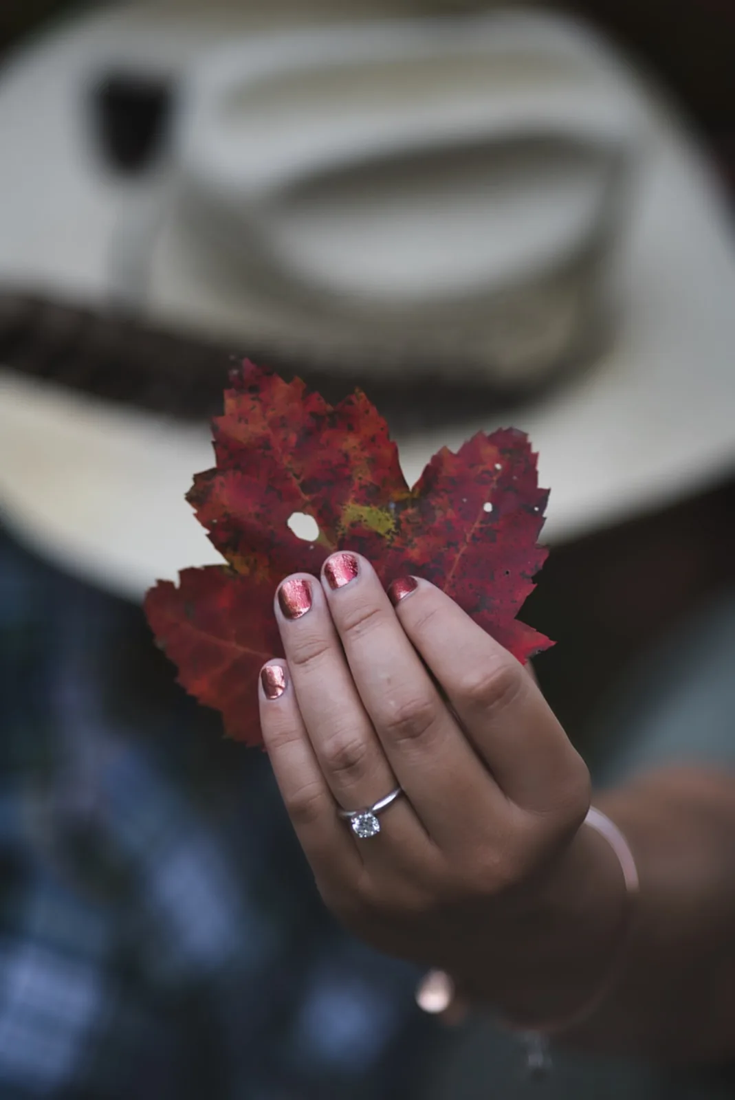 couple close portrait, cowboy hat, fall red foliage backdrop
