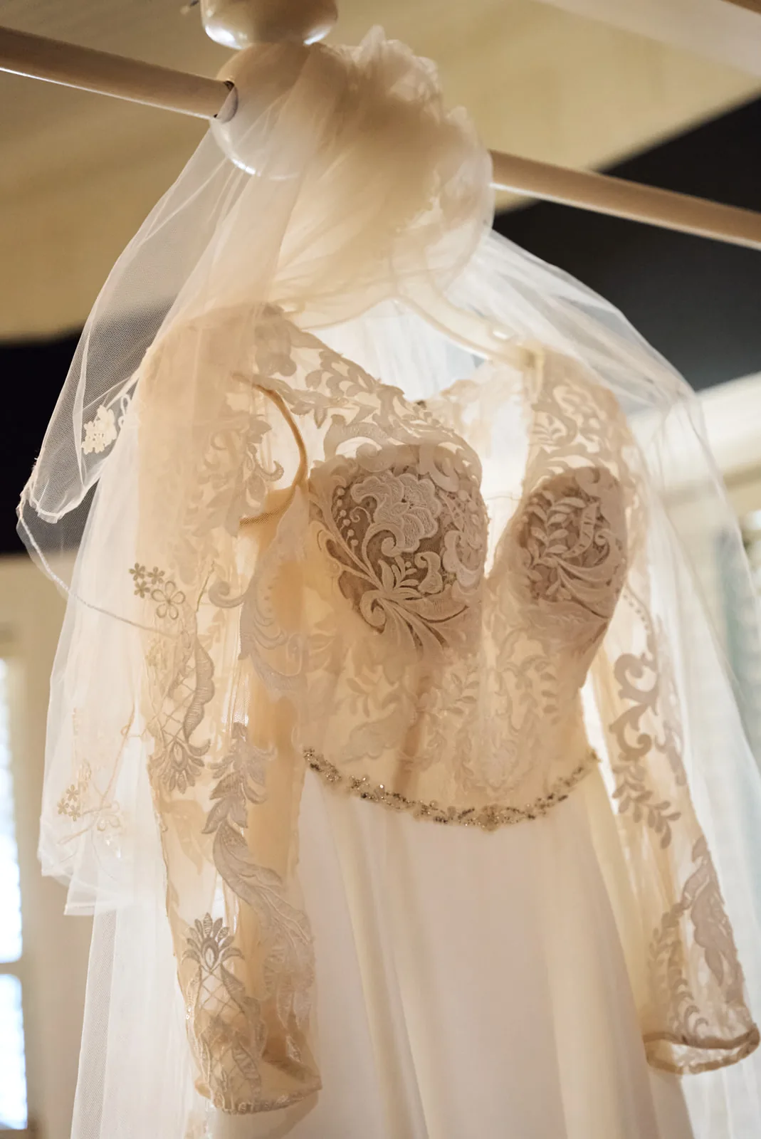 detail of lace wedding dress back hanging