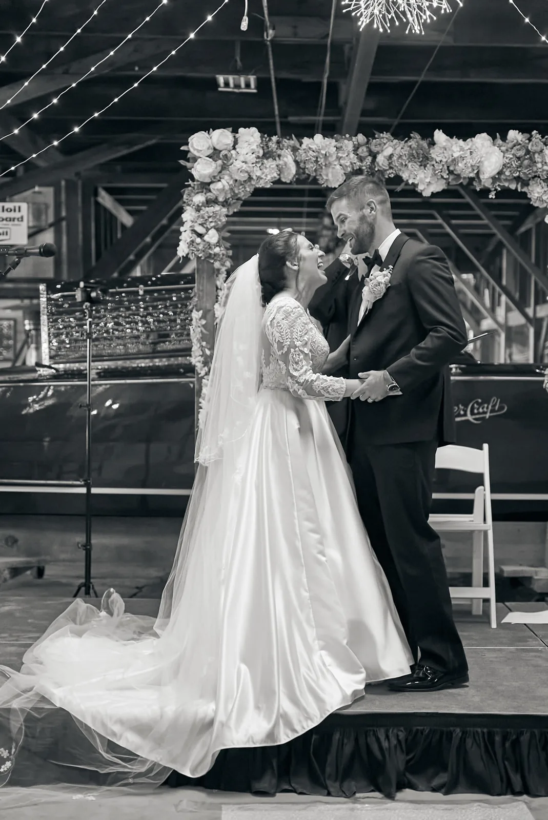 bride and groom at altar, string lights overhead