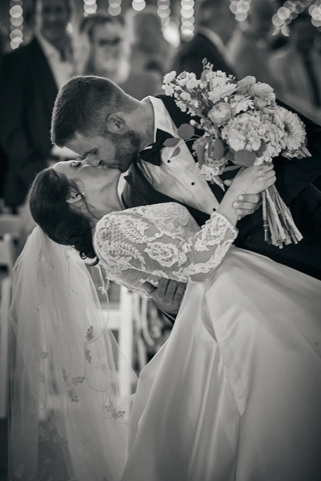 bw close-up bride and groom kissing, bouquet visible