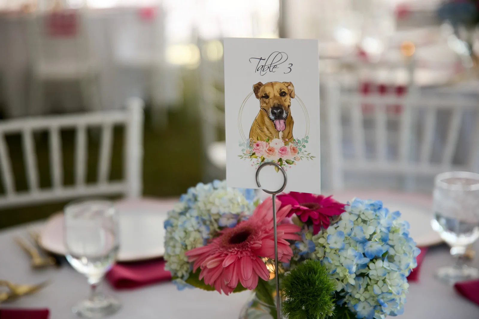 wide shot of reception tent tables set with pink linens