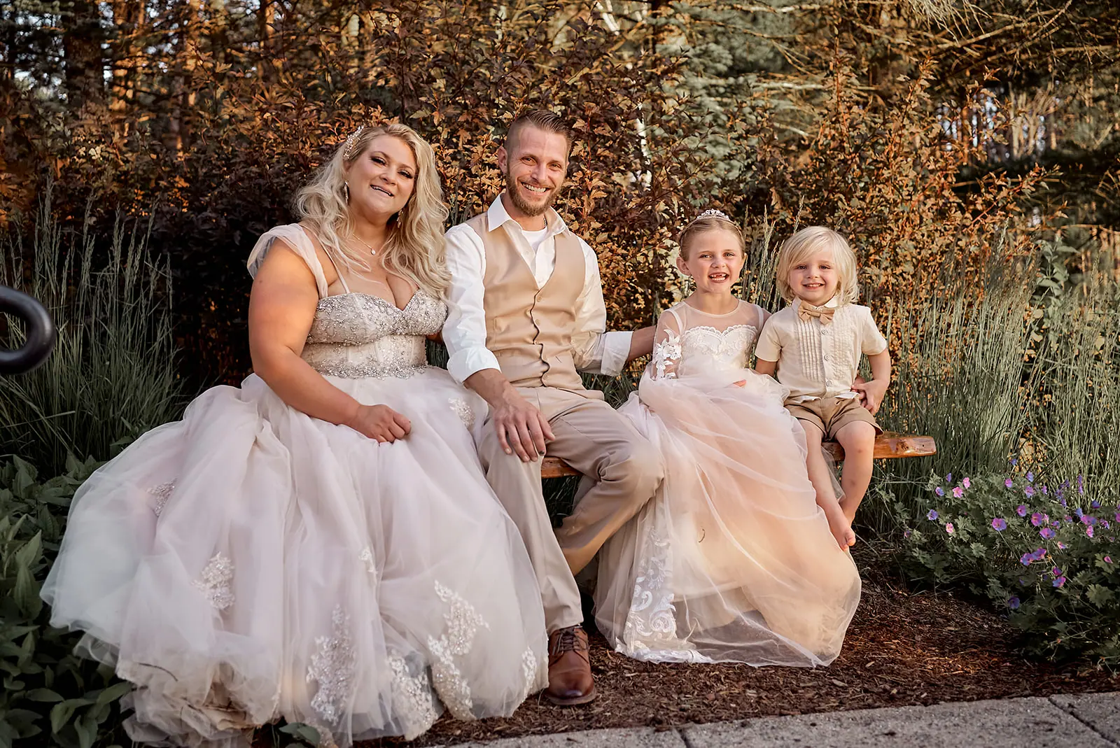 Bride groom two girls seated bench — Erika & Corey's wedding at Sojourn Lakeside Resort, Gaylord, MI