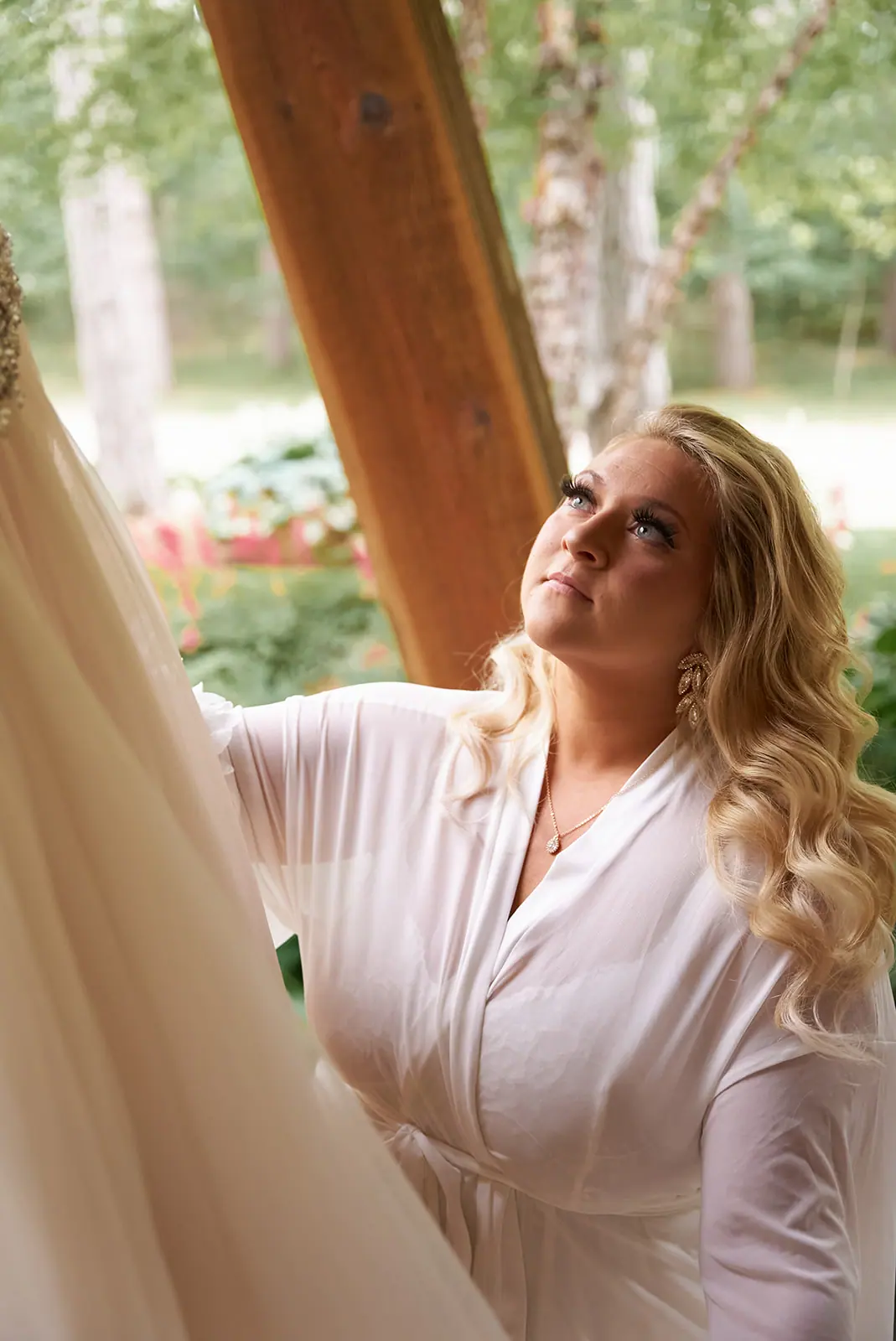 Bride robe looking pavilion beam — Erika & Corey's wedding at Sojourn Lakeside Resort, Gaylord, MI
