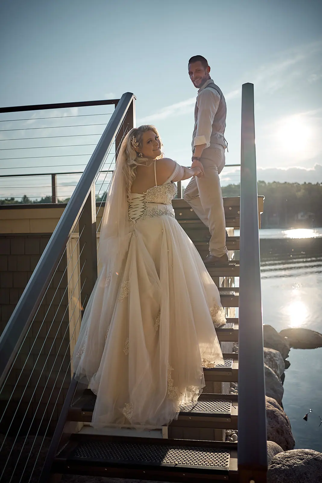 Bride walking dock stairs groom waits — Erika & Corey's wedding at Sojourn Lakeside Resort, Gaylord, MI
