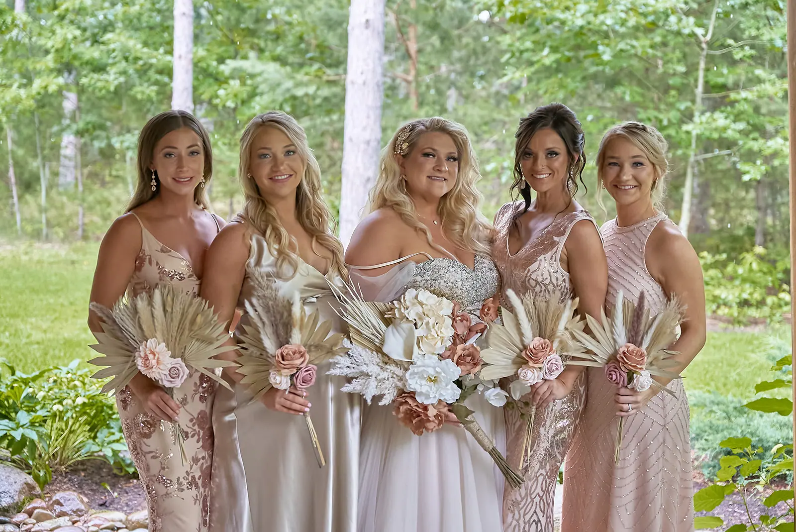 Bridesmaids champagne gold holding bouquets patio — Erika & Corey's wedding at Sojourn Lakeside Resort, Gaylord, MI