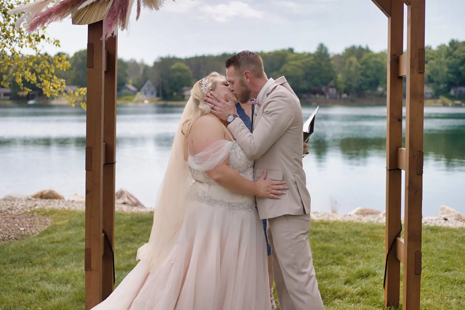 Couple embracing lake vows — Erika & Corey's wedding at Sojourn Lakeside Resort, Gaylord, MI