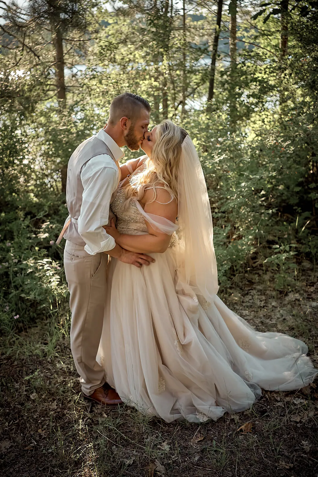 Couple embracing woods veil flowing — Erika & Corey's wedding at Sojourn Lakeside Resort, Gaylord, MI