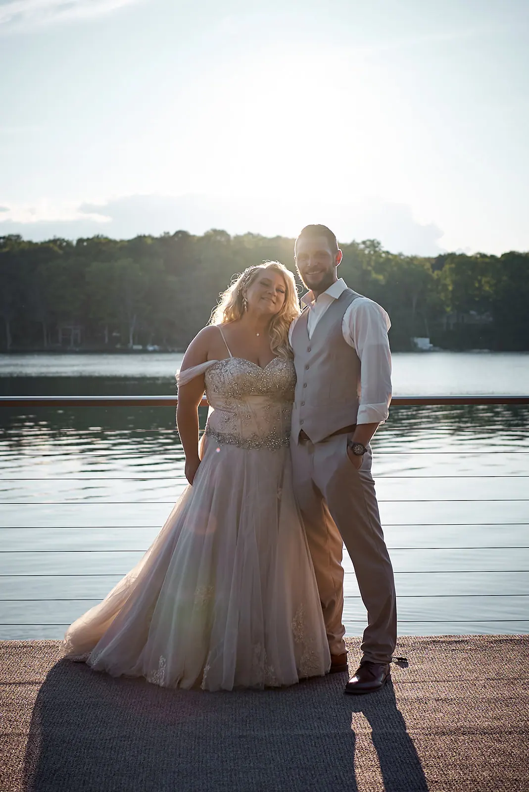 Couple standing dock sunset backlit — Erika & Corey's wedding at Sojourn Lakeside Resort, Gaylord, MI