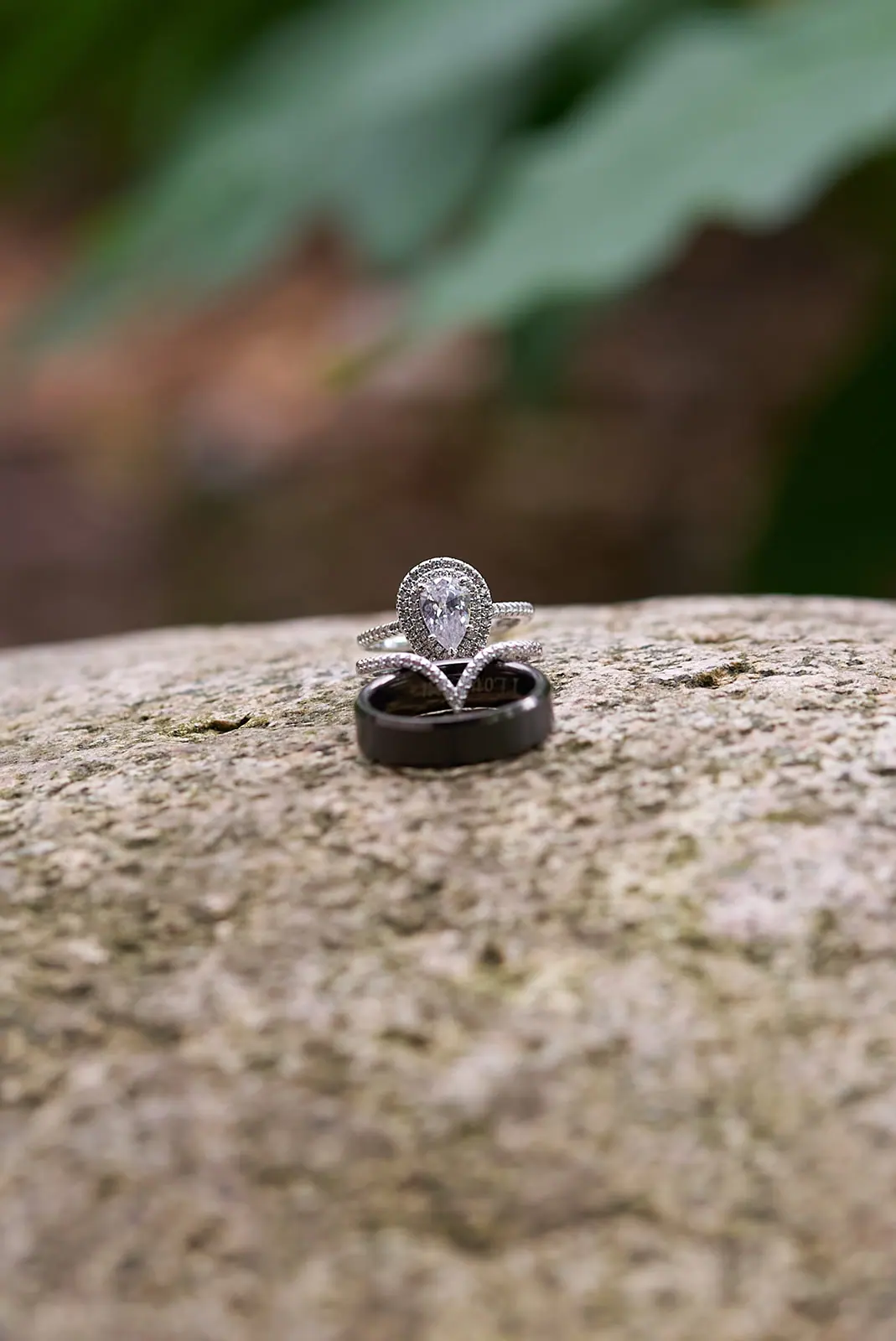 Engagement ring resting rock — Erika & Corey's wedding at Sojourn Lakeside Resort, Gaylord, MI