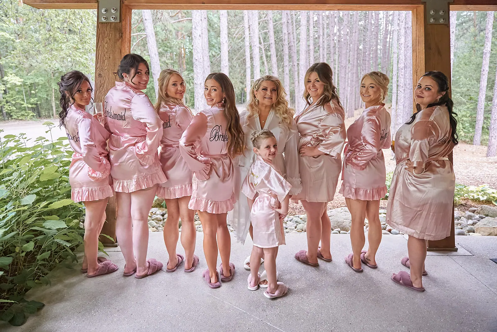 Girls bridesmaids pink robes standing together — Erika & Corey's wedding at Sojourn Lakeside Resort, Gaylord, MI