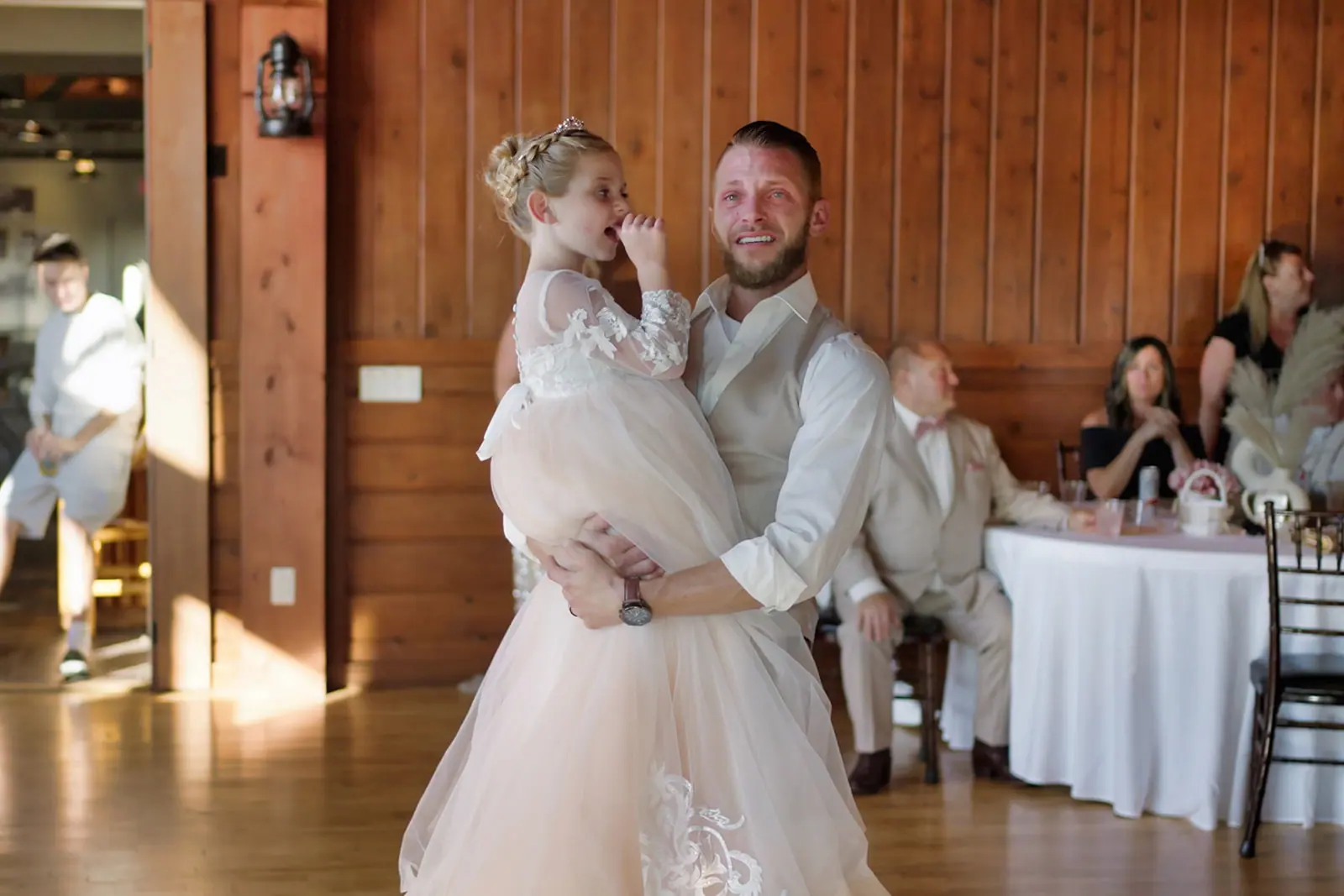 Groom dancing holding flower girl lodge — Erika & Corey's wedding at Sojourn Lakeside Resort, Gaylord, MI
