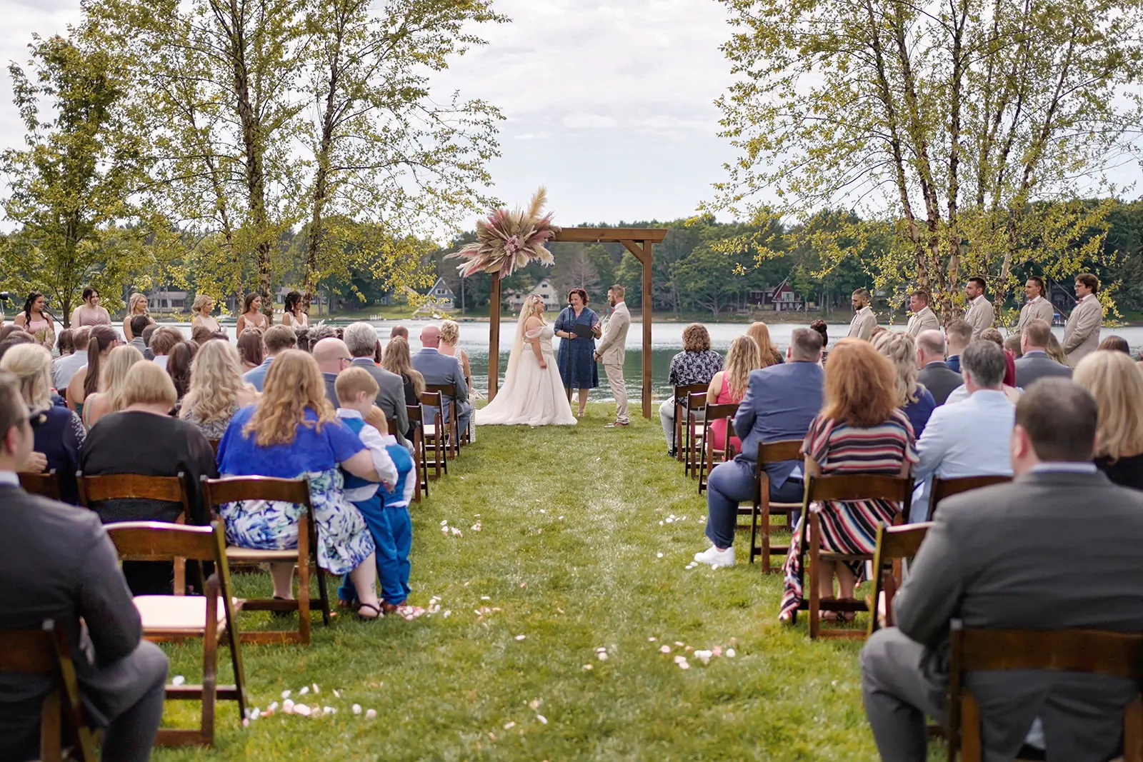 Seated guests rows facing arch lawn — Erika & Corey's wedding at Sojourn Lakeside Resort, Gaylord, MI