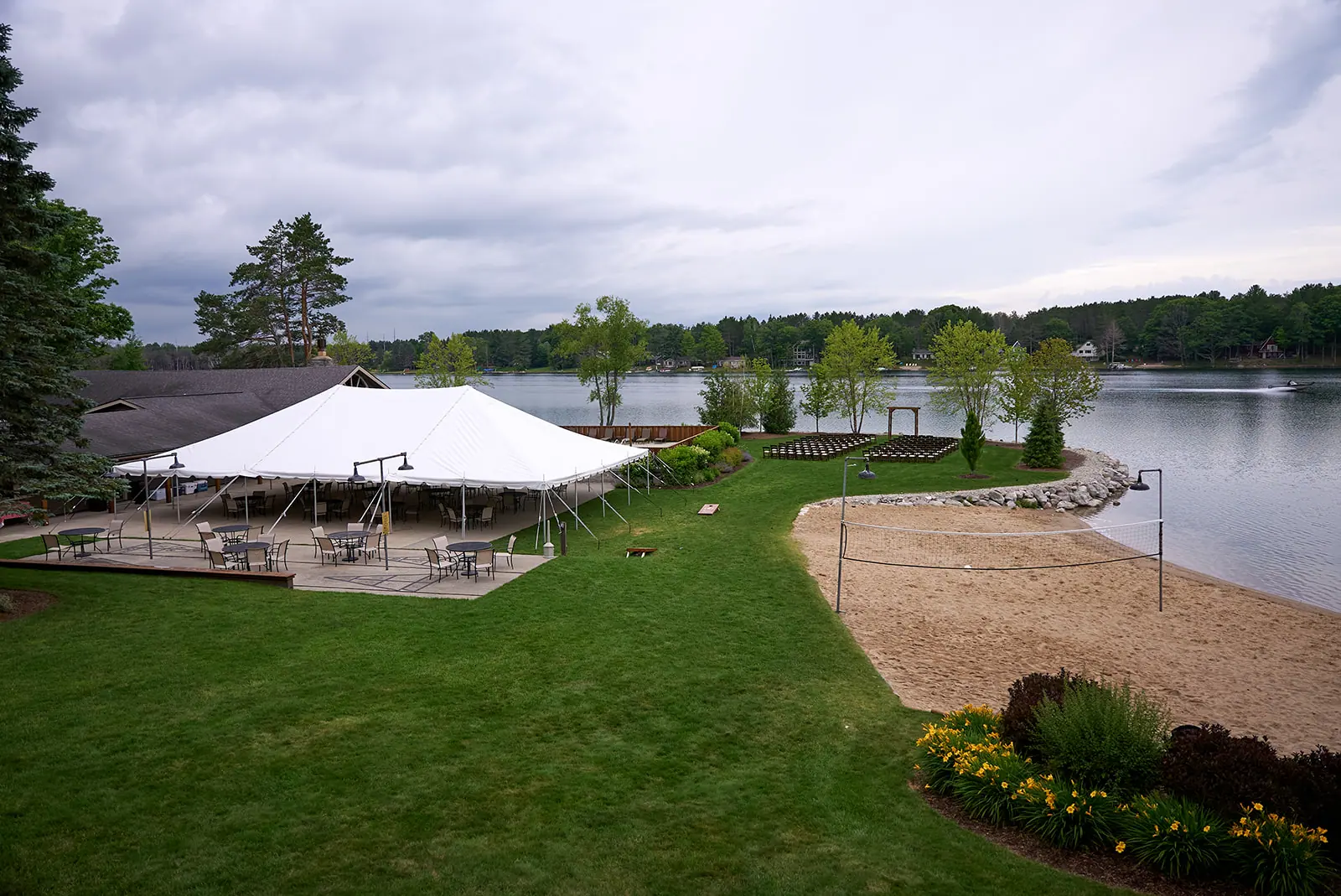 Wide view reception tent lawn lake — Erika & Corey's wedding at Sojourn Lakeside Resort, Gaylord, MI