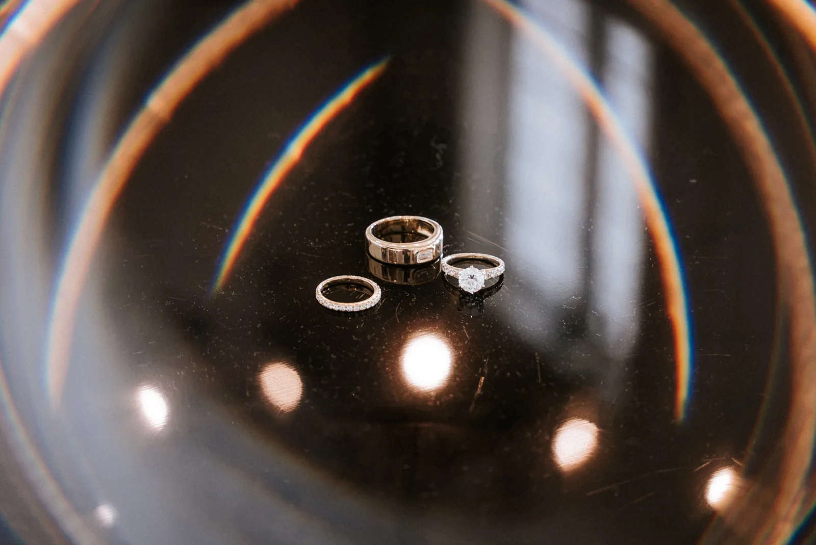detail of wedding rings through glass/prism effect, candlelight