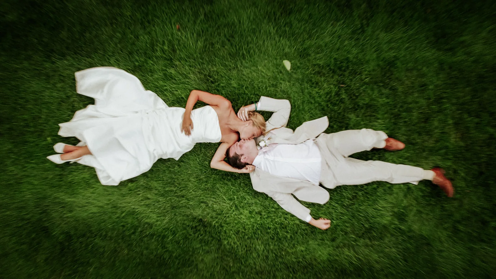 bw couple lying in grass laughing together, close-up