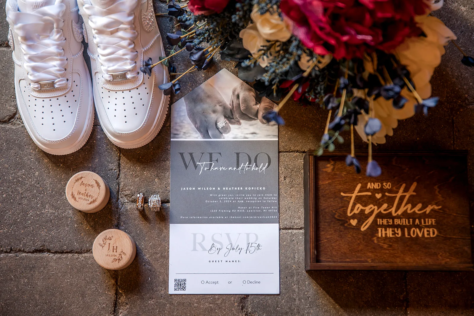 detail flatlay of white sneakers, rings on cork, invitation suite