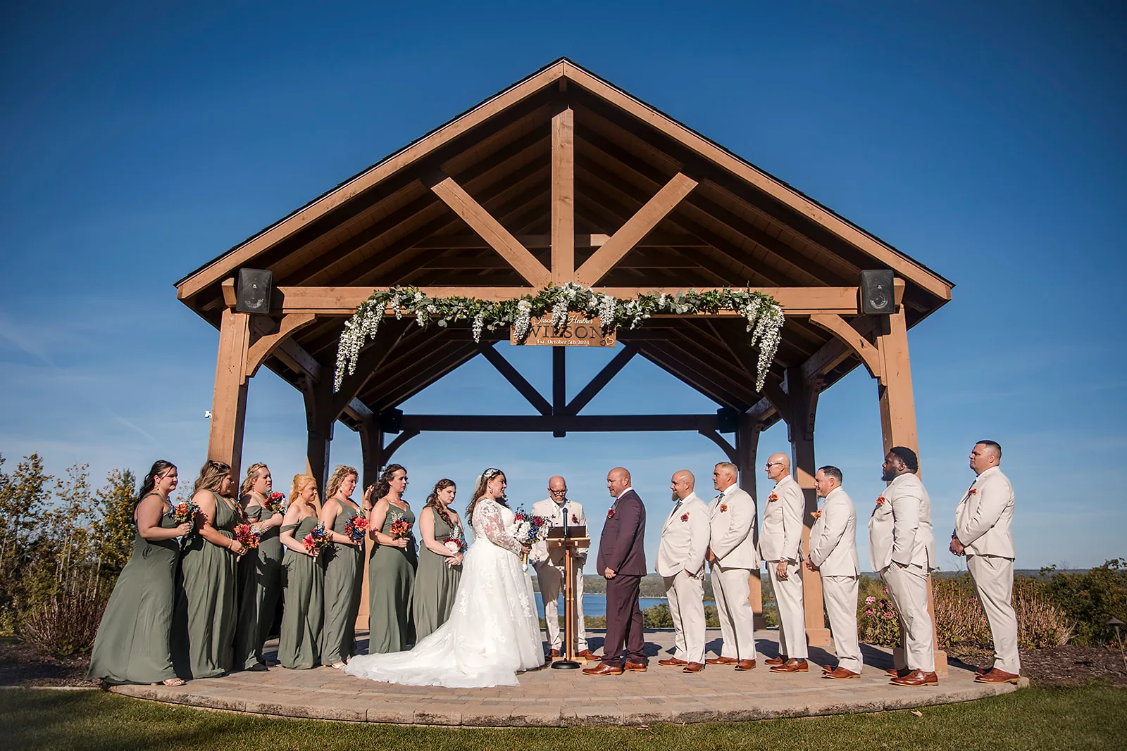 wide shot of bride walking down aisle, guests seated