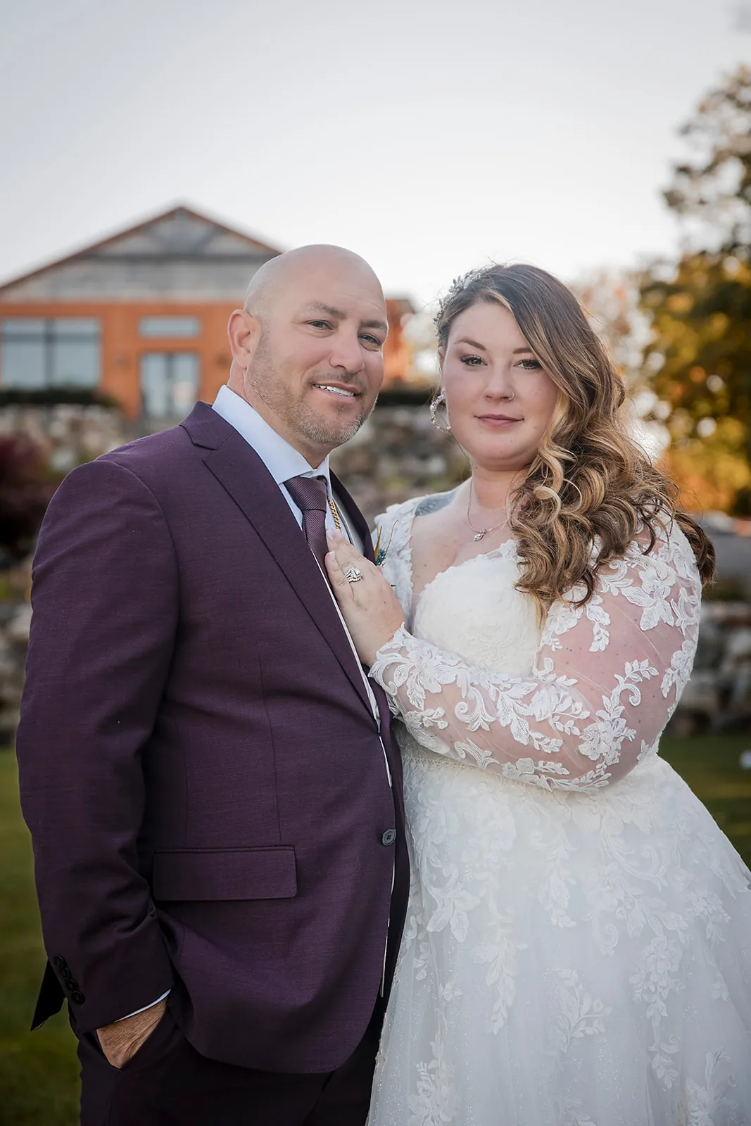 bride and groom portrait backlit by golden sunset through trees