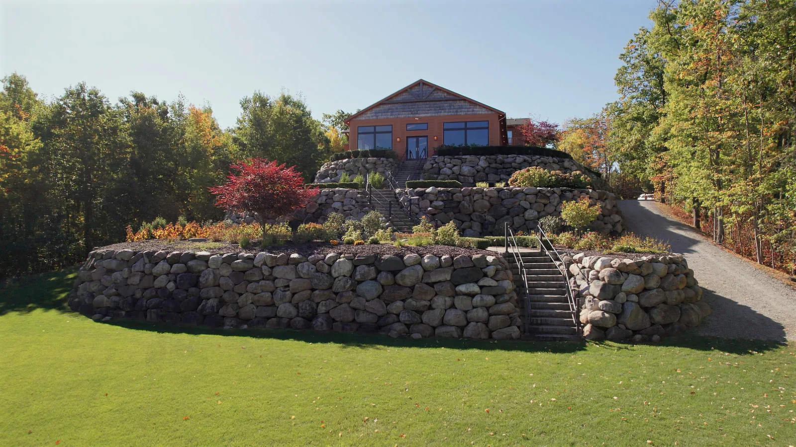 aerial/drone wide shot of stone-terraced manor venue grounds