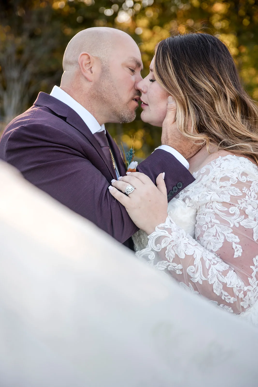 bride and groom portrait together, manor building in background
