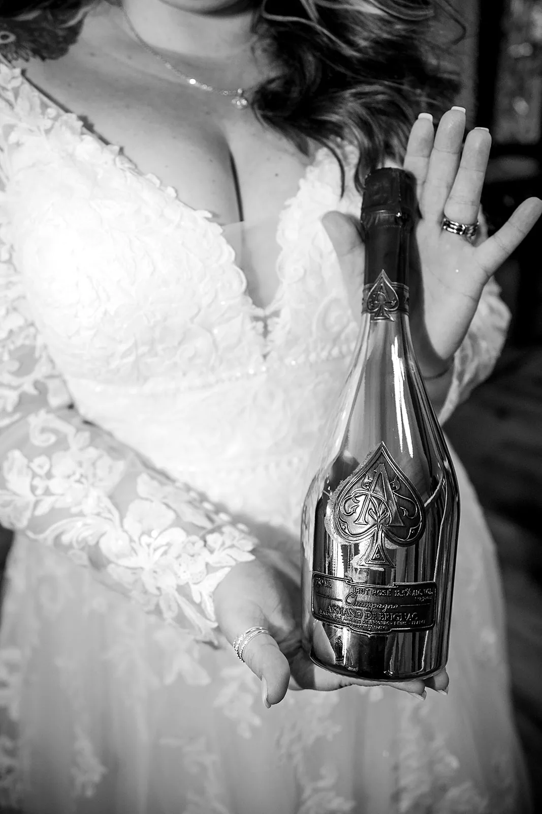bw candid bride and groom making funny faces with guest, reception