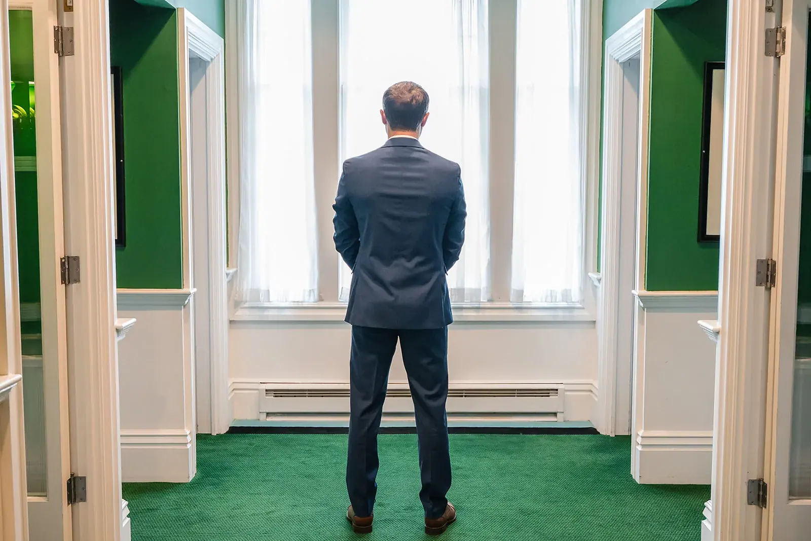 Groom waiting first look window — Jennifer & Parker's wedding at the Grand Hotel, Mackinac Island