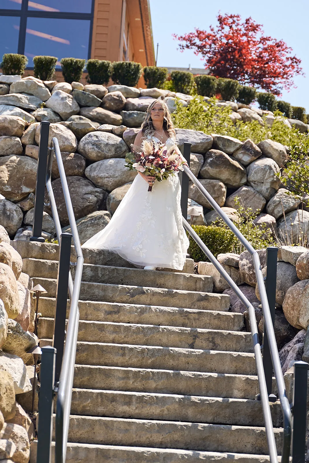mother helping bride with dress and bouquet, getting ready candid