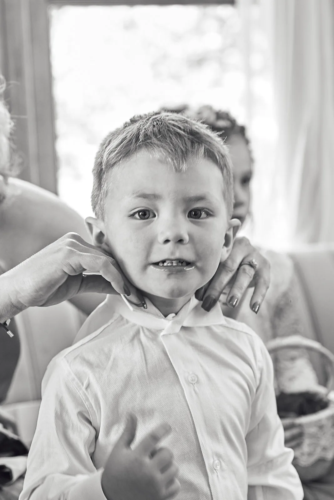 bw close portrait of young ring bearer boy making face