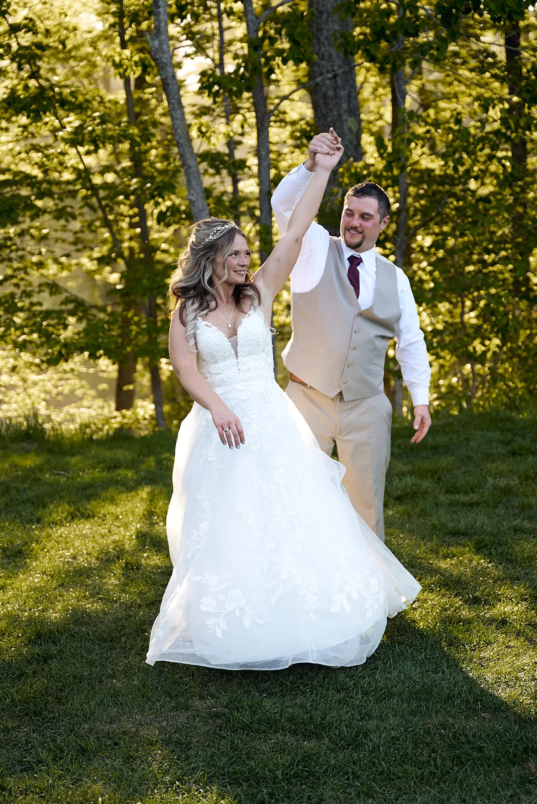 bride and groom playful dance, groom spinning bride, lawn
