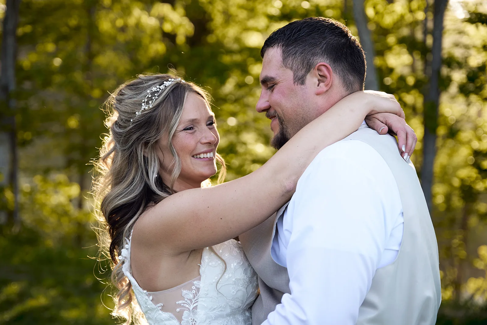 bride and groom close portrait smiling, forest backdrop