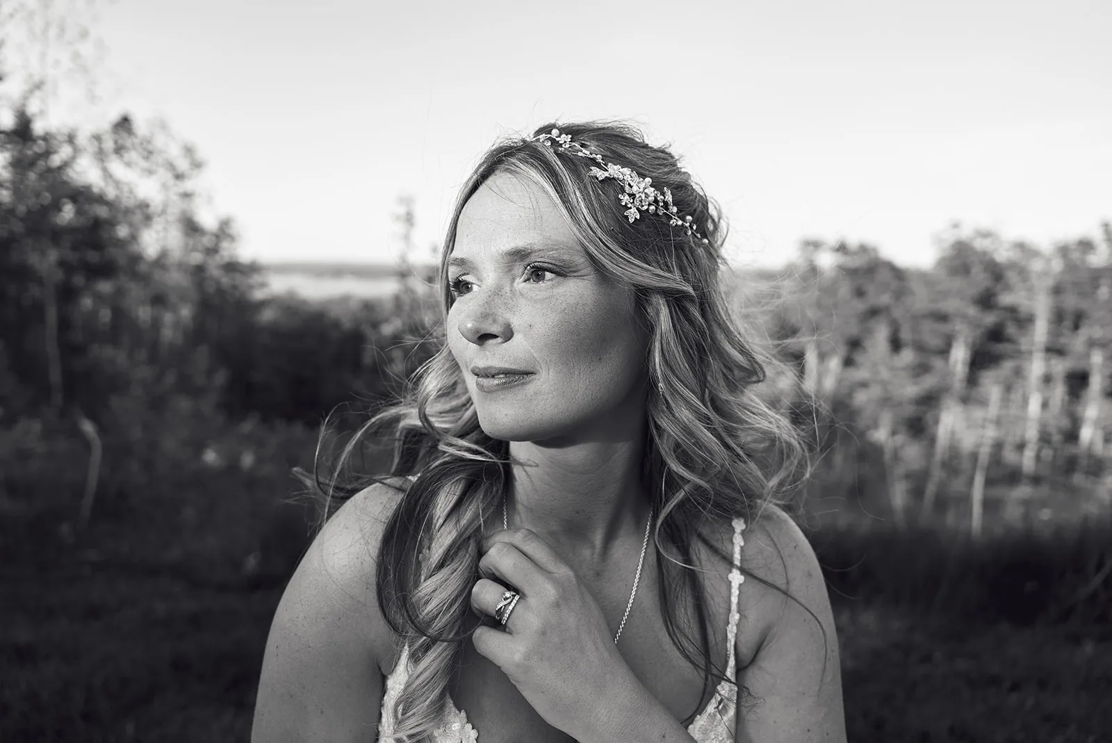 bw bride profile portrait with wind blown hair, outdoors