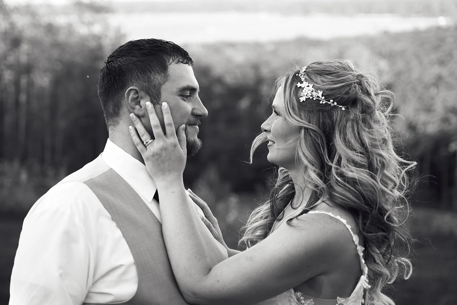 bw bride and groom close embrace, hand on face, emotional