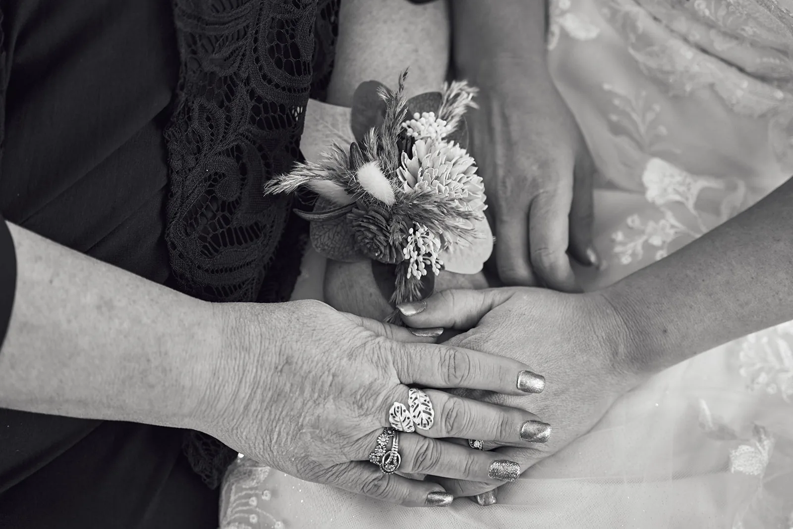 bw detail of bride hand on groom arm, wedding rings visible