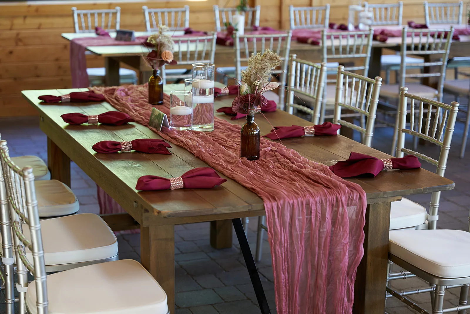 wide shot of reception hall interior, string lights and tables