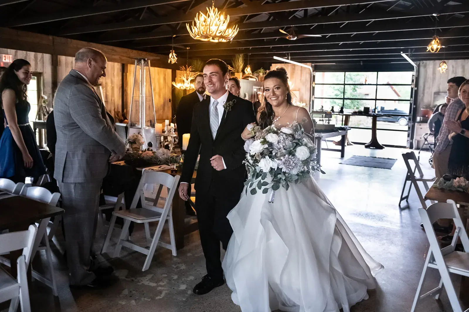 Bride and groom barn reception entrance — Jessica & Joel's wedding at The Rut Hutt, Gaylord