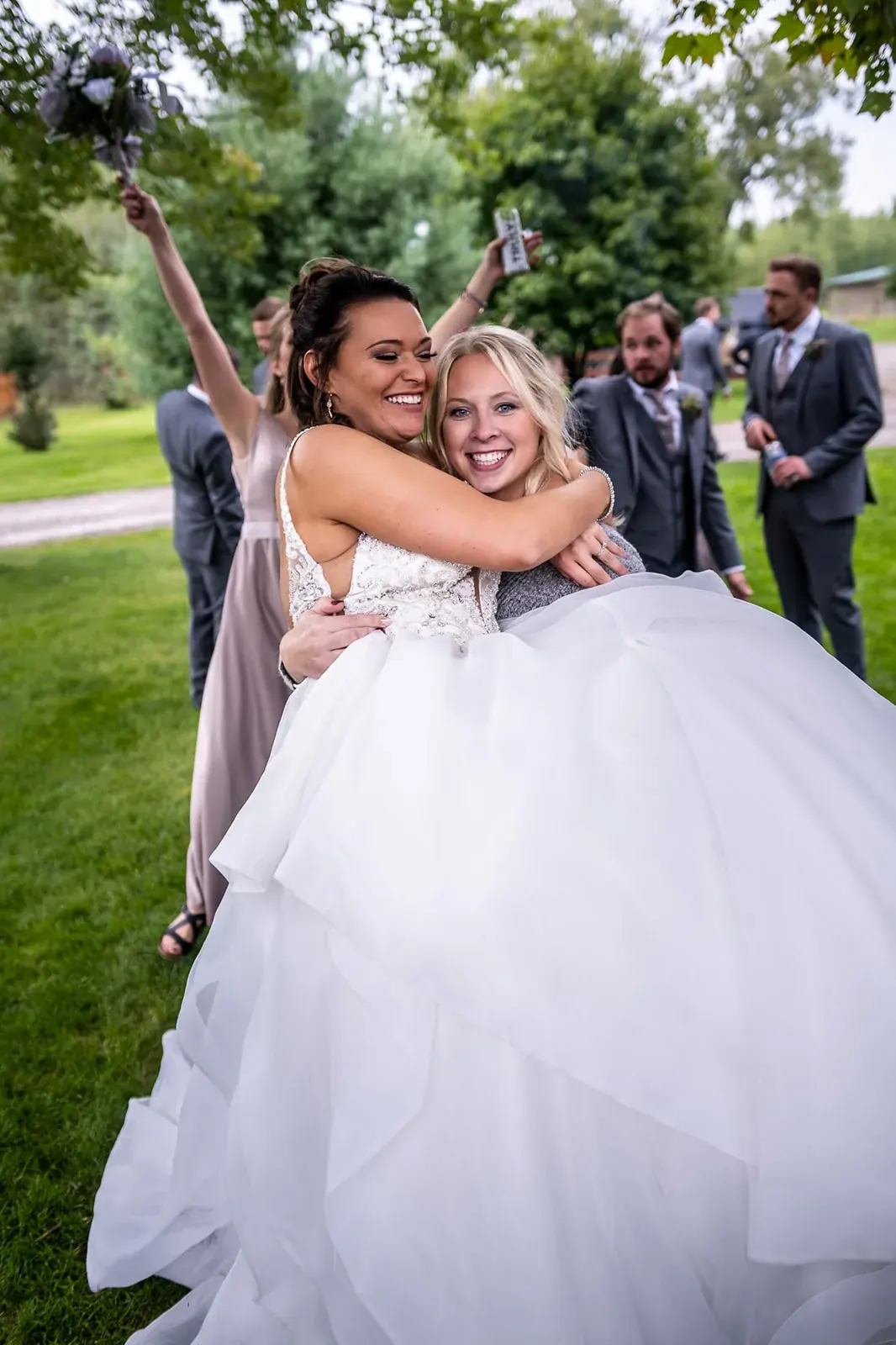 Bride lifted celebrating — Jessica & Joel's wedding at The Rut Hutt, Gaylord