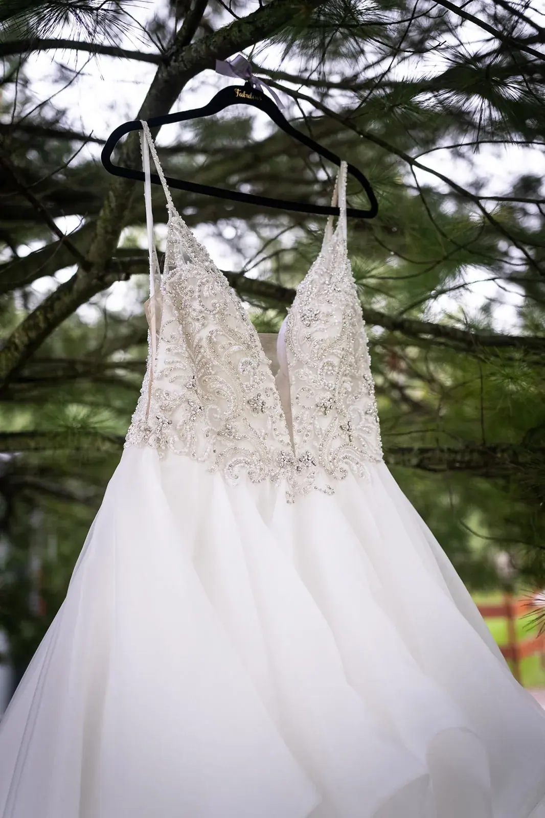 Wedding dress hanging pine tree — Jessica & Joel's wedding at The Rut Hutt, Gaylord