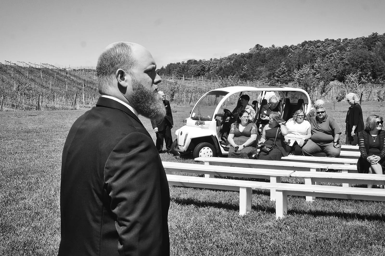 bw wide shot bride and groom first kiss, guests watching