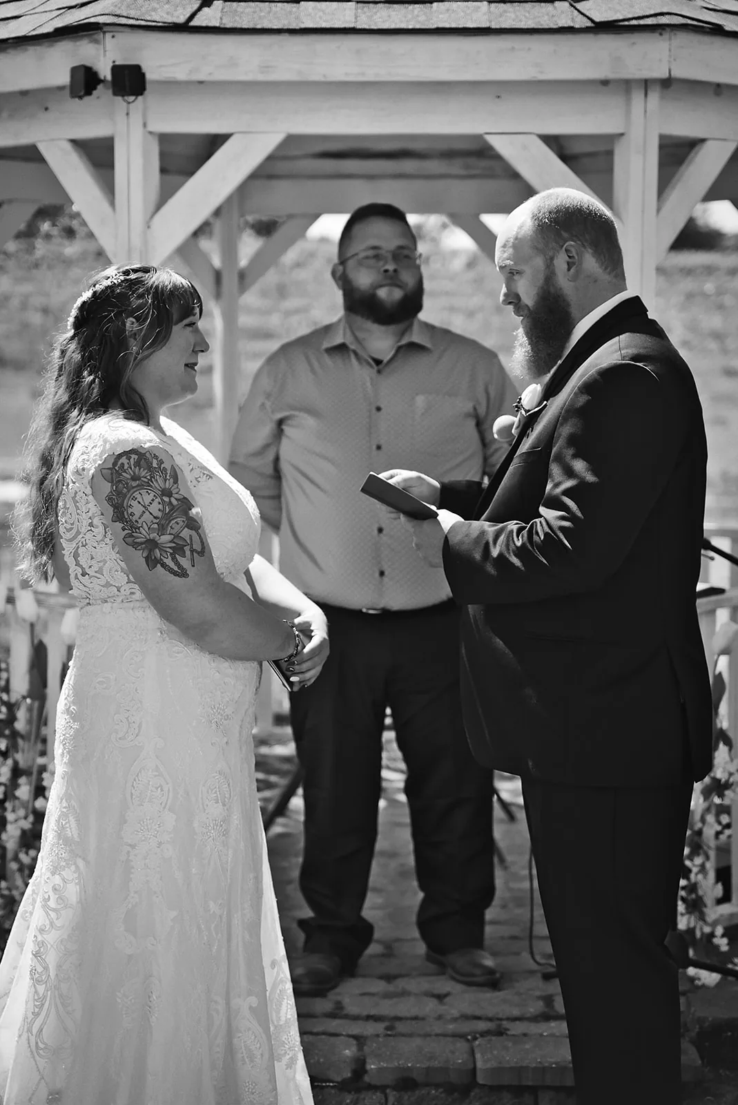 bw close portrait of officiant marrying couple, hands joined